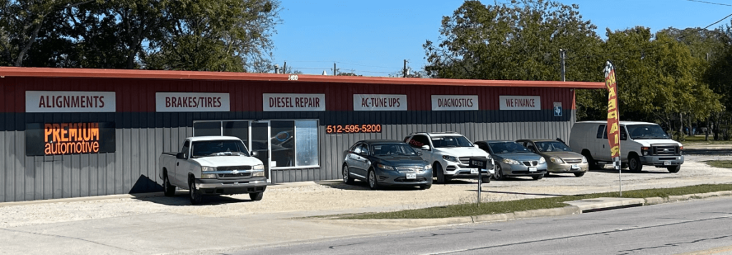 The exterior of Premium Automotive in Taylor, TX, with cars parked in front to receive auto repair services
