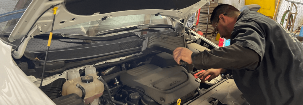 A Premium Automotive technician works on the transmission of a vehicle - Auto repair